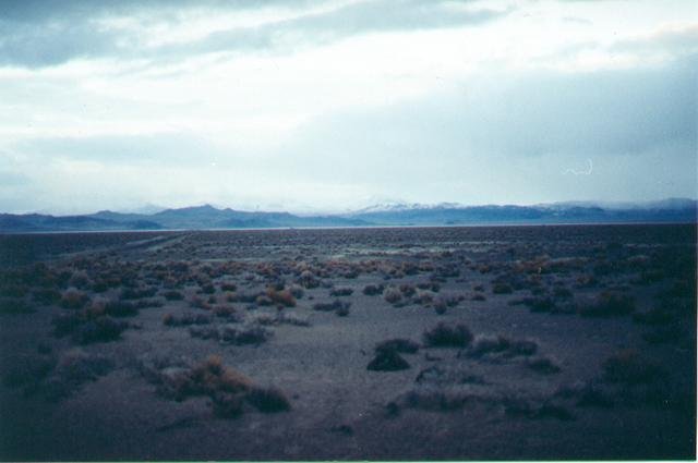 Confluence point cairn in foreground, looking north