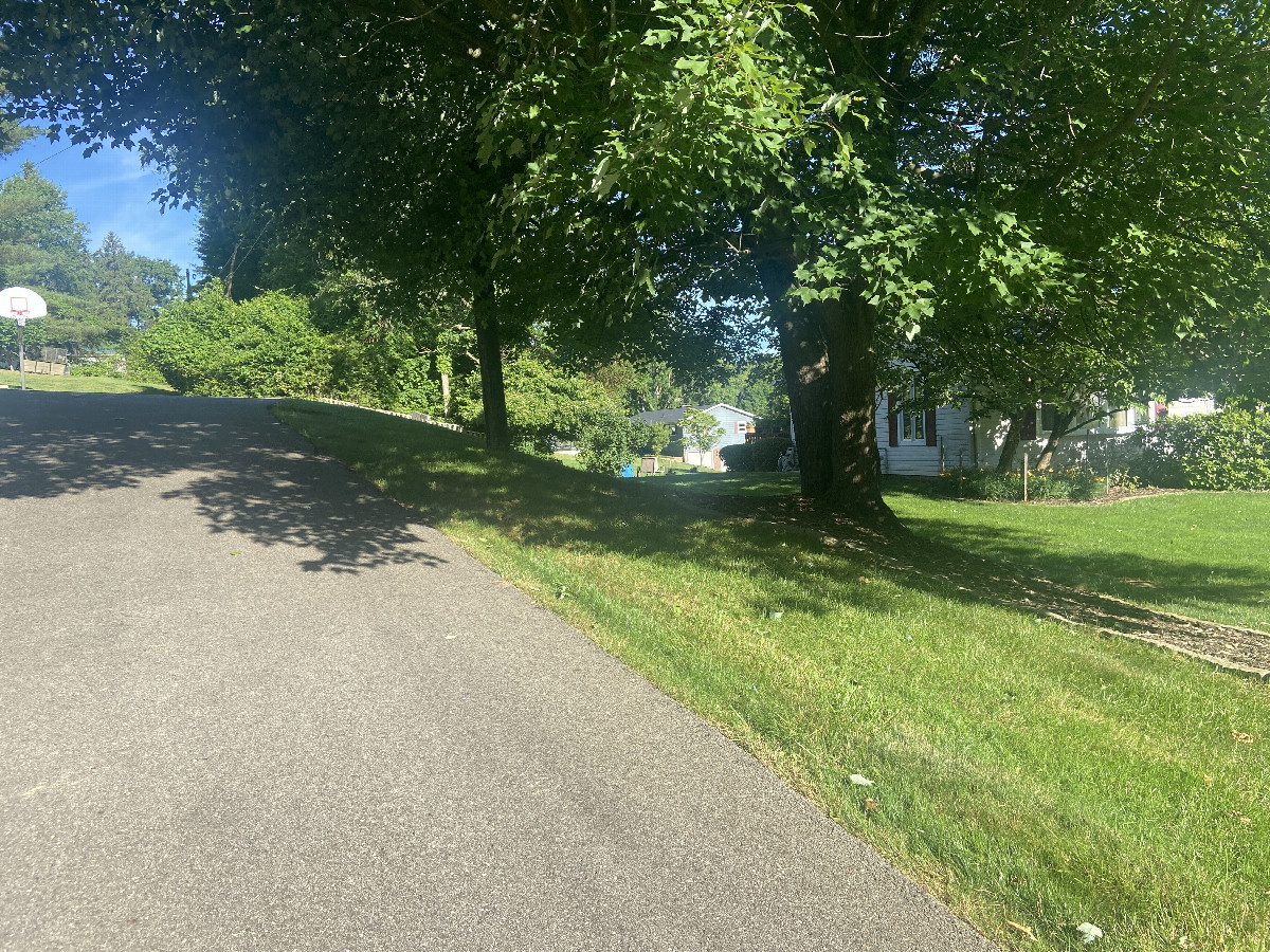 The confluence of 40° north 82° west on the left side of his driveway.  Due to the northwest. 