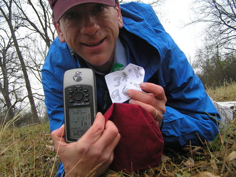 Joseph Kerski at the confluence point, lying down in the rain in the field.