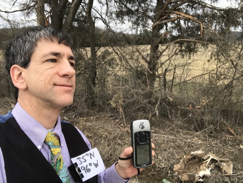 Joseph Kerski posing next to cattle remains at 35 North 96 West. 