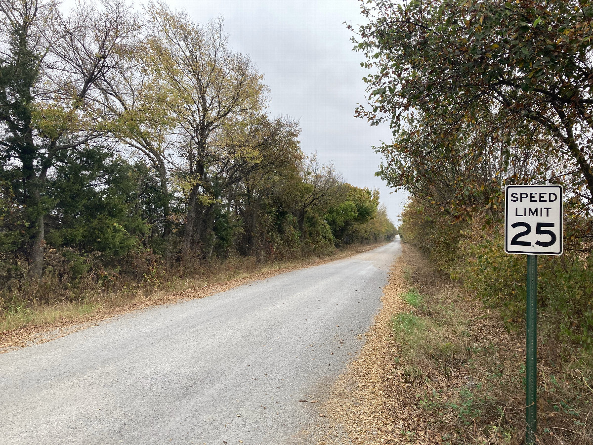 Looking east toward 35N 96W, located a bit down the road where the surface visibly changes, before the opposite-facing sign