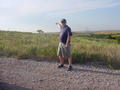 #2: Eric points the way. The confluece is about 100 ft. north of that lonely tree.