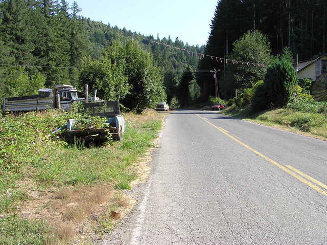 View South (along Myrtle Creek road).  More junked vehicles...