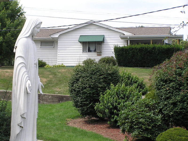 The confluence of 40 North 80 West is adjacent to Mary's left elbow, on the south-facing lawn, looking north-northwest.