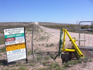 #1: Looking towards confluence point 2 miles away at oilfield gate