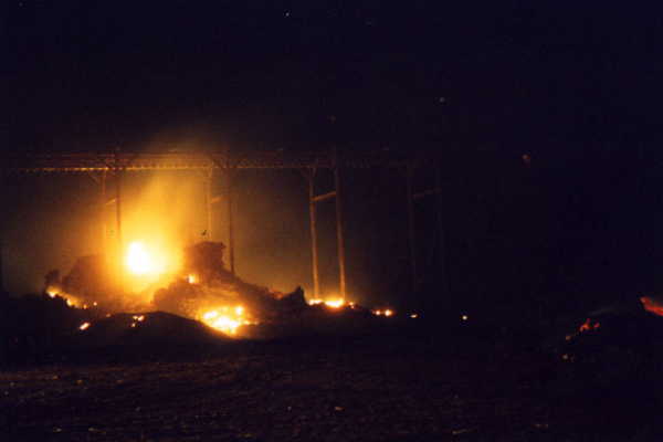 Flaming hull heaps at Cotton Center Gin