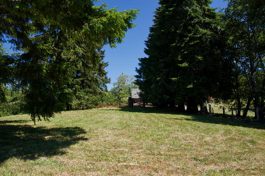 #1: The confluence point lies 143 feet away, in the front yard of this private residence.  (This is also a view to the East.)