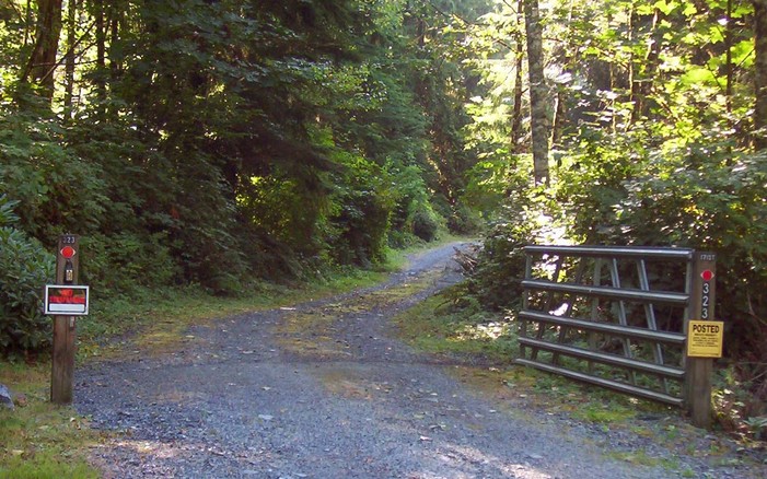 Gate with "No Trespassing" sign.