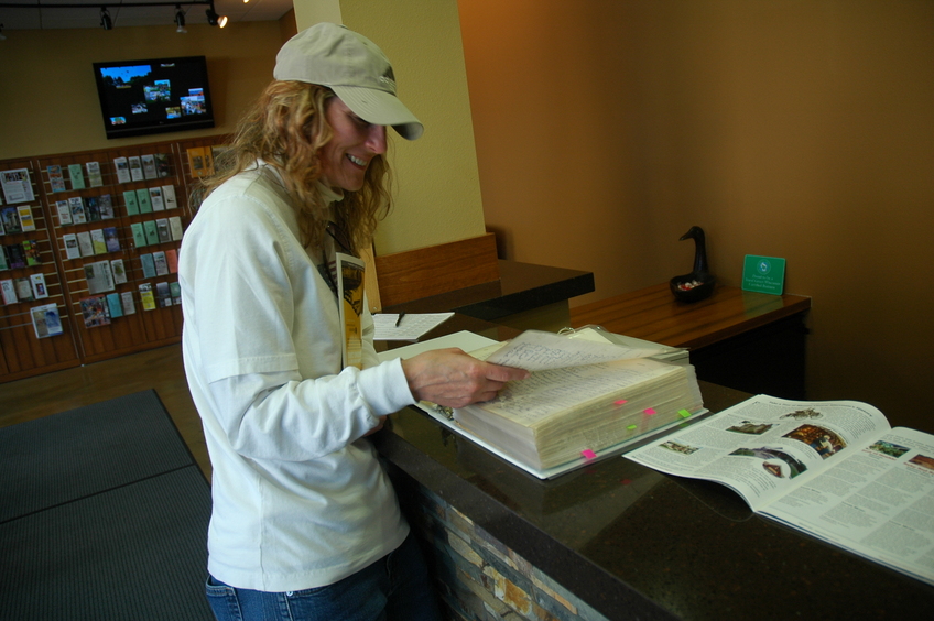 Ginger reads the 45x90 Club log book