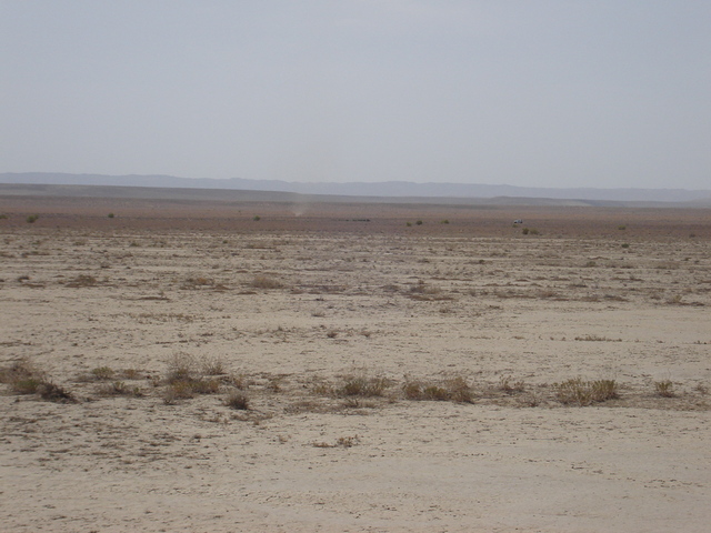 the car and a dust devil beside it