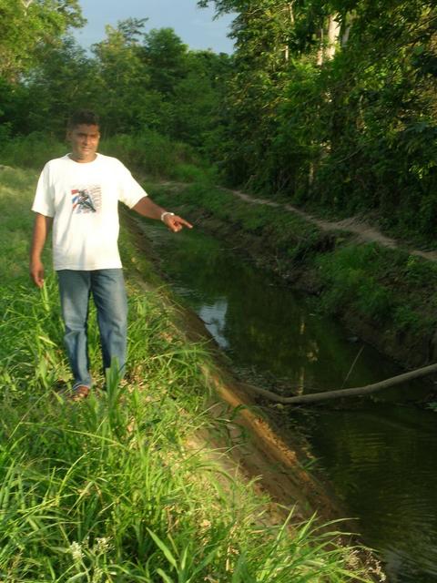 Local guy showing irrigation trenches