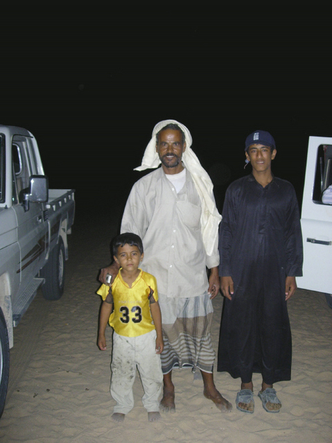 Nasr, his infant son, and Ma'tib (modelling his England Cricket Team cap)