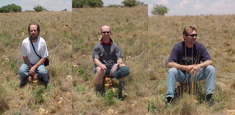 Steven, Roland, and Henning sitting on the cairn under the overhead sun (notice the shadows?)